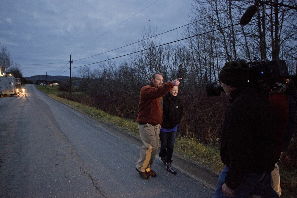 Wilbur and Hickox walk down their street in Fort Kent on Friday. She has refused to remain quarantined at home while being monitored for Ebola, but she and Wilbur say they’ll respect residents’ wishes and not go into town until the incubation period ends Nov. 10.