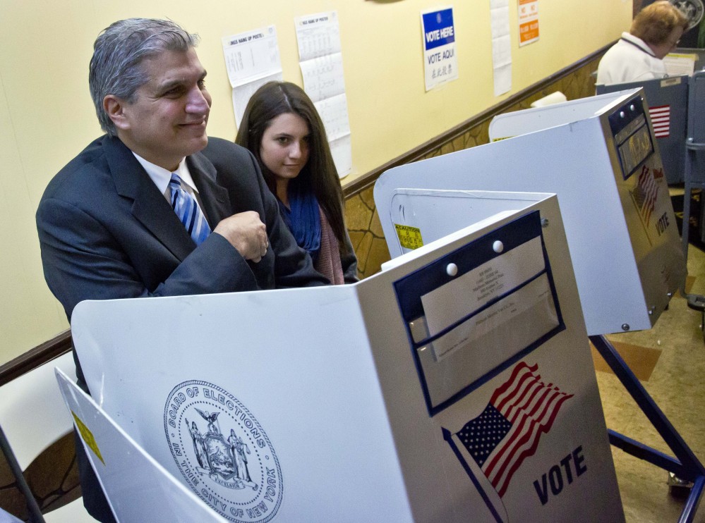 With his daughter Brianna at his side, Democratic U.S. House candidate, former Democratic City Councilman Domenic Recchia smiles after voting Tuesday in New York. Recchia is challenging embattled two-term Republican Staten Island U.S. Rep. Michael Grimm.