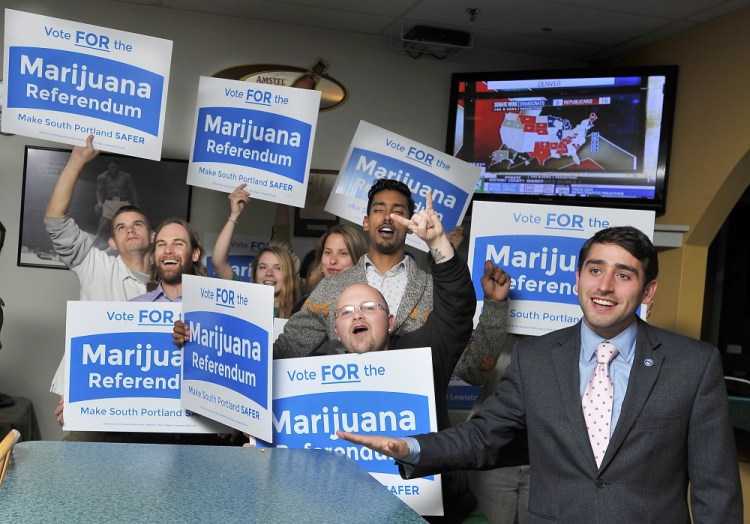 Advocates celebrate voter approval Tuesday of a South Portland referendum to legalize possession of small amounts of marijuana by adults. David Boyer, right, is political director of the group leading the legalization movement in the state.