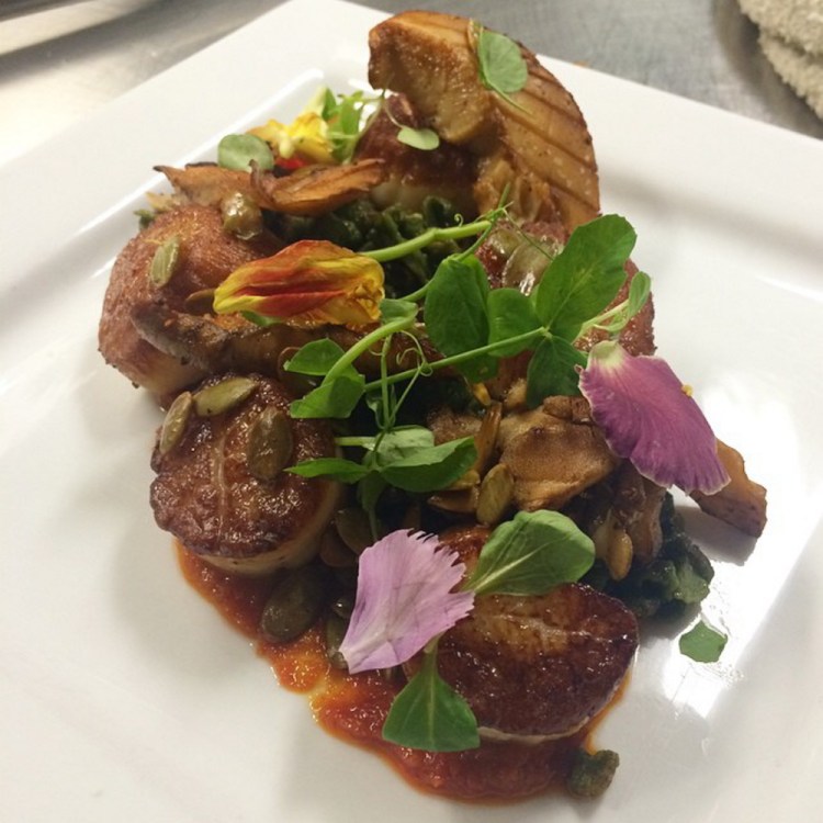 Fathom’s seared sea scallops with spinach spaetzle, MDI-foraged pinenuts and maitake mushrooms, sun-dried tomato pesto and toasted pumpkin seeds.