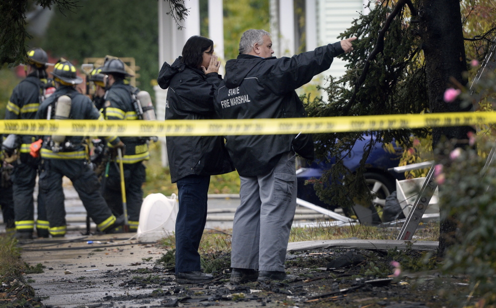 Officials with the State Fire Marshal’s Office visit the scene of an apartment building fire on Noyes Street in Portland on Nov. 1. Five people died in the fire and a sixth victim died of his injuries at a Boston hospital last week.