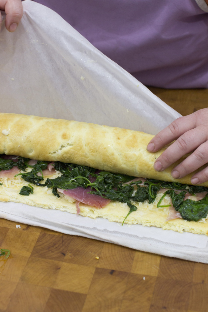 Making an egg roulade stuffed with prosciutto, spinach and roasted red pepper.