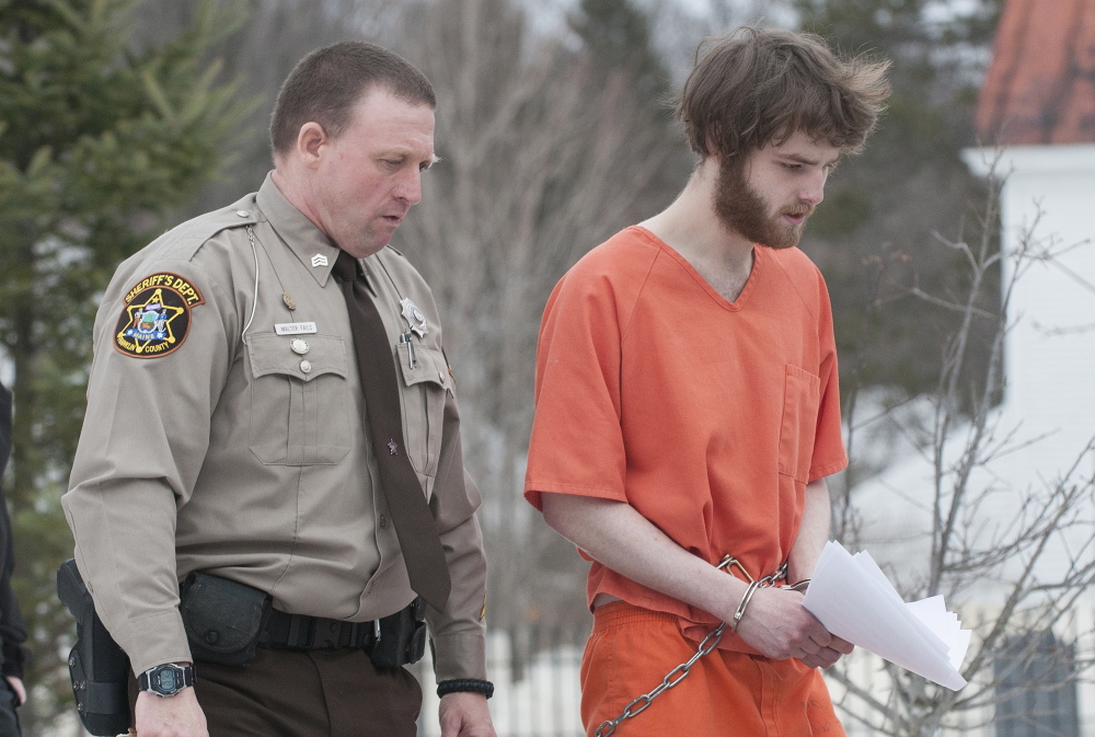 Dana Craney, right, is escorted to a waiting jail transport by Franklin County Sheriff Deputy Walter Fail after Carney’s initial appearance in Franklin County Superior Court in Farmington on Monday.