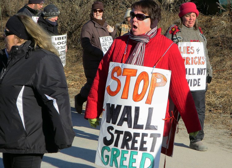 Striking FairPoint Communications workers walk a picket line outside the company's state headquarters Tuesday in Portland. The National Labor Relations Board has dismissed complaints accusing FairPoint of bargaining in bad faith. 