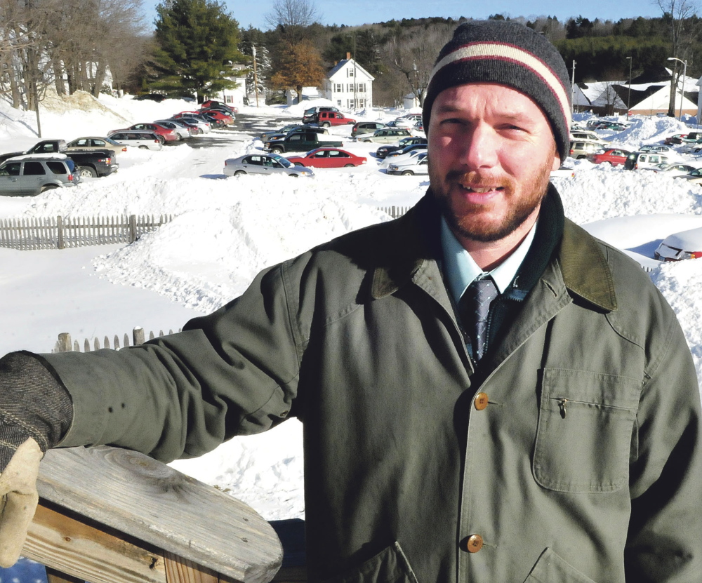 Jeff McKay, director of facilities management for the University of Maine Farmington, stands in the campus parking lot where the new central heating plant fired by wood chips will be located.