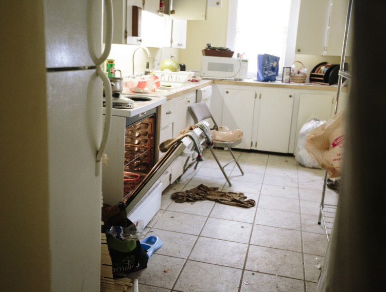 Socks hang over the door of an oven being used as a source of heat Thursday at 188 Dartmouth St.. a Portland property owned by Gregory Nisbet that has been targeted for safety violations.