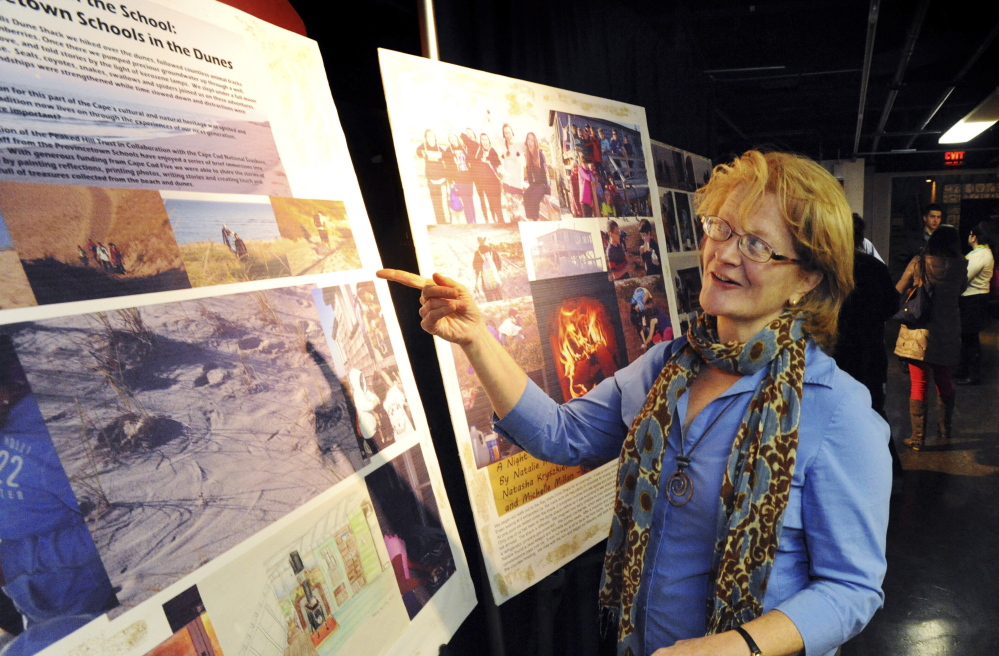 Provincetown teacher Nancy Flasher shows off a display that she helped her students create, at Cape Cod Community College in West Barnstable, Mass. She is one of many teachers who are turning to mini-grant funding to enhance teaching and learning.