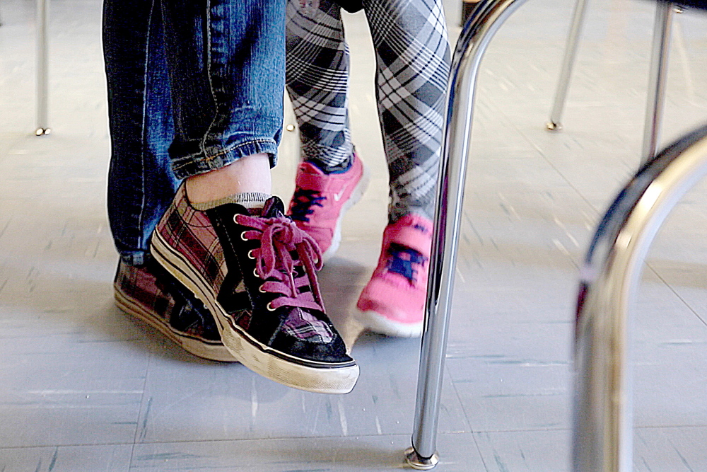 Kialeigh Marston, 17, sits at a table at Buxton Center Elementary School with 6-year-old Bayley Rafuse-Morse, right, as the two read together. The Teen Trendsetters program is funded in part by a grant from the Barbara Bush Foundation.