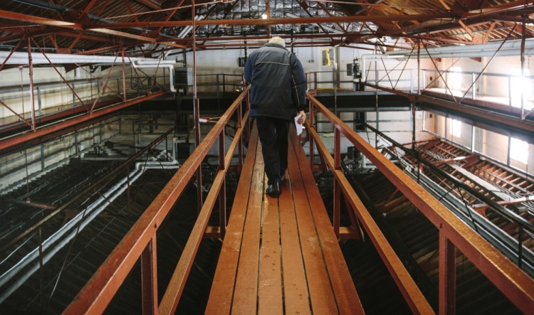 Norm Labbe, superintendent of the Kennebunk water district, tours the treatment plant on Wednesday. He thinks the question of fluoridation should be decided by customers.