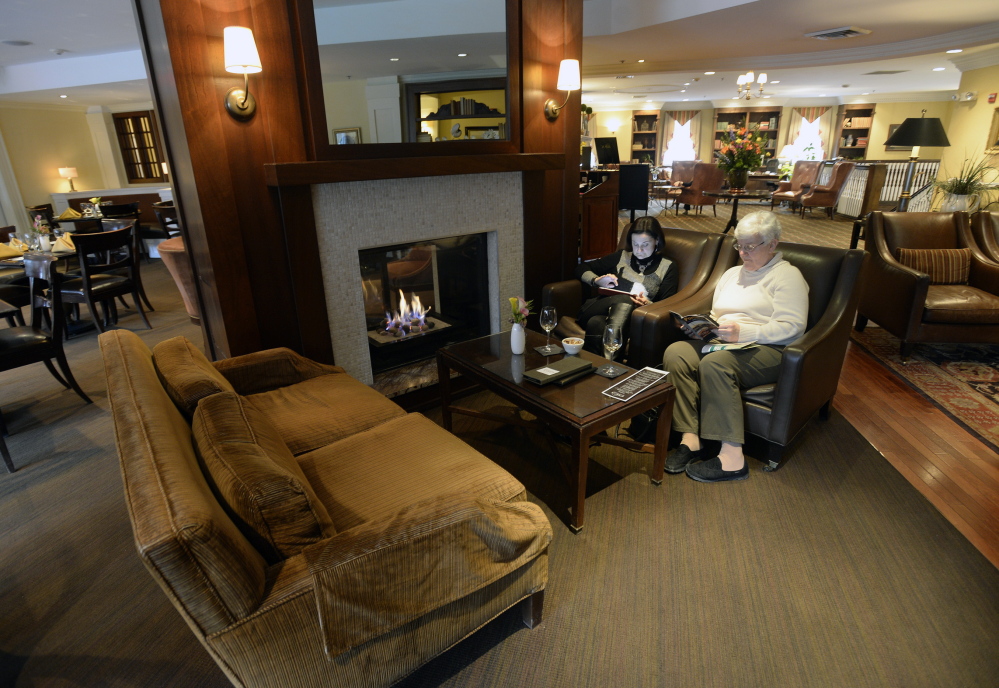 Guests enjoy a glass of wine near Eve’s double-sided fireplace.