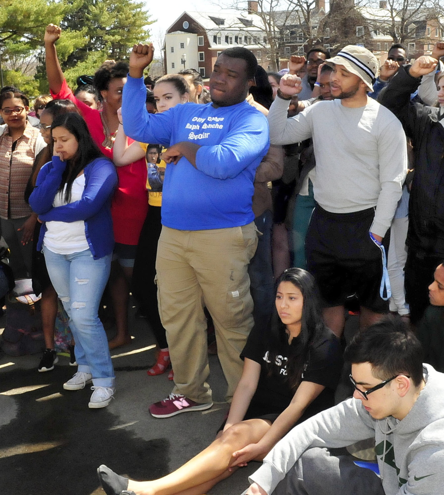 Colby College students gesture in support of comments made by speakers during a racial issue forum on the Waterville campus Thursday.