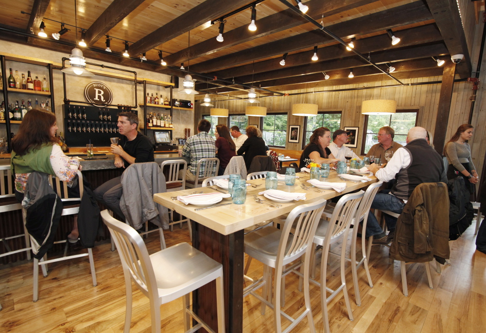 A high community table dominates the dining room at Rudy’s of the Cape.