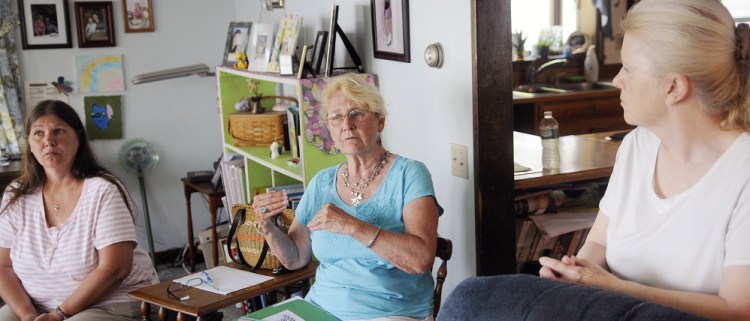 Jan Strout of West Gardiner, center, speaks at a recent meeting in Belgrade of the Augusta Area Kinship Support group for grandparents raising their grandchildren. Brenda Beaulieu, left, of Fairfield, and Jan Partridge of Belgrade Lakes are in the group.