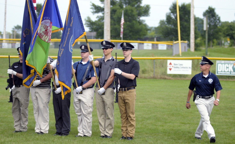 Augusta police Sgt. Christian Behr, right, checks the alignment of police officers Thursday during color guard rehearsal at Rivelli Little League Field in Augusta. The Augusta Police Honor Guard will be presenting the colors Friday for the Red Sox game at Fenway Park.