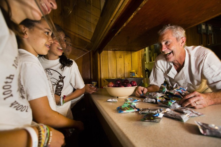 Chef Jonny St. Laurent chats with campers over the snack counter at Camp Walden in Denmark.