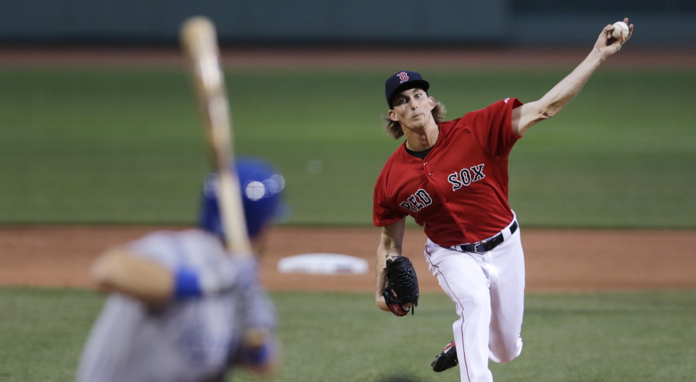 Boston Red Sox starting pitcher Henry Owens delivers a pitch in the first inning of the Red Sox’ 7-2 win Friday night in Boston. Owens pitched eight innings to earn the victory.