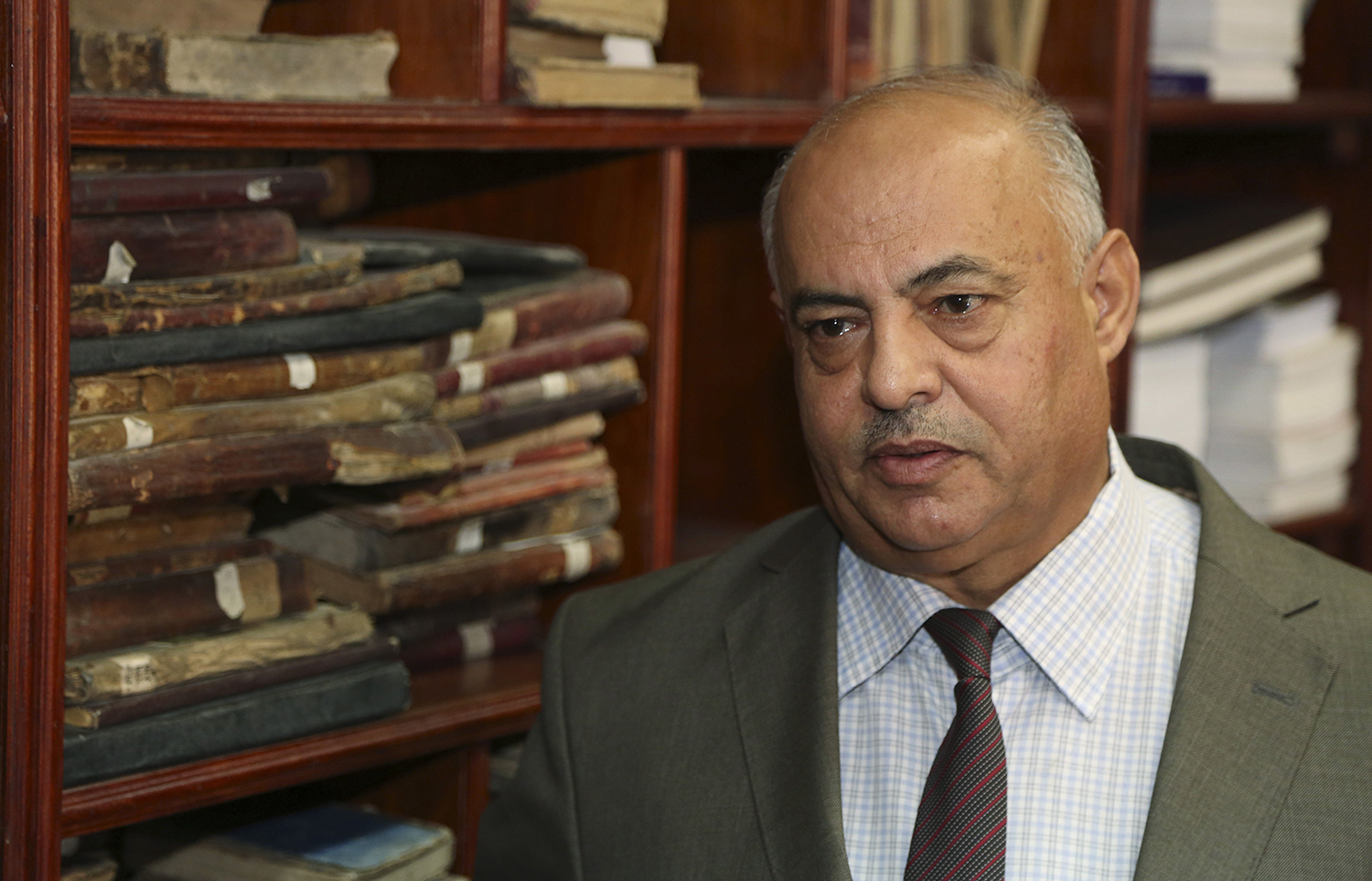 Jamal Abdel-Majeed Abdulkareem, acting director of Baghdad libraries and archives, speaks during an interview with The Associated Press at the Baghdad National Library in Iraq. The Associated Press