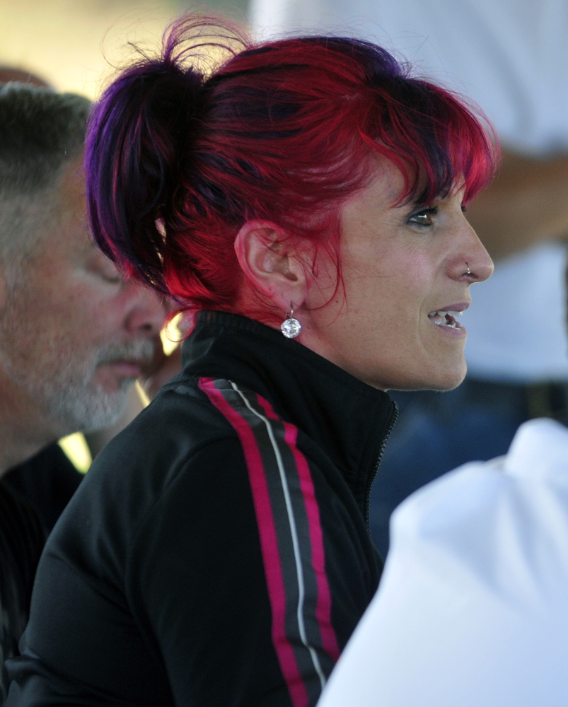 Gina Lomonaco, owner of GEvolution Fitness on Water Street, asks about downtown foot patrols Thursday during a public meeting in the Mill Park gazebo in Augusta.