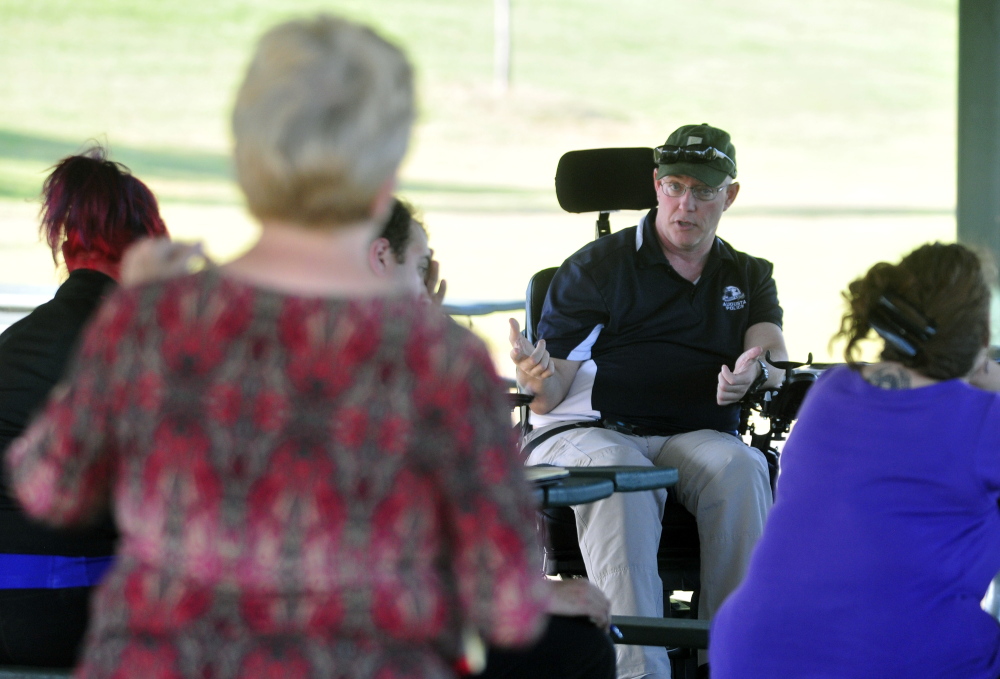 Augusta police Chief Robert Gregoire answers a question from an audience member Thursday during a public meeting in the Mill Park gazebo in Augusta.