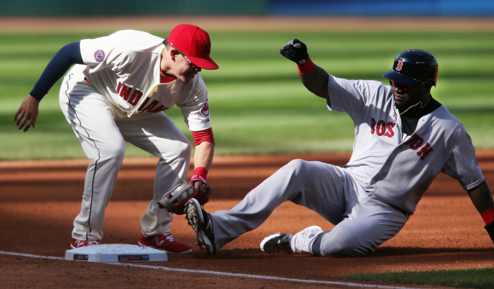 Boston’s David Ortiz, right, is tagged out by Cleveland’s Giovanny Urshela while attempting to steal third base during the first inning Sunday in Cleveland.