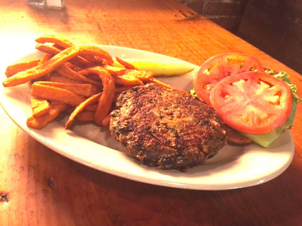 At The Liberal Cup in Hallowell, the veggie burger has lentils, black beans, carrot, potato, green onion and a secret spice blend. The restaurant sells about 200 of them a week.