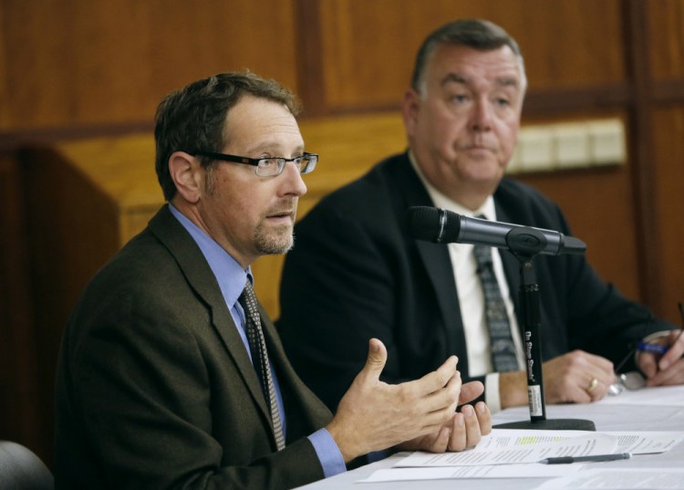 Dr. Christopher Pezzullo, left, seen with Kenneth Albert in October at the University of Maine School of Law, will continue as the state health officer while the Maine CDC operates without a director. Albert was the agency's director until May.