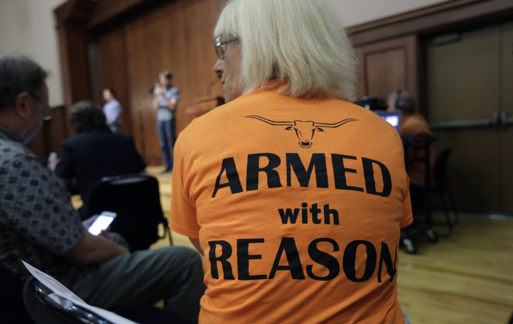 Professor Ann Cvetkovich waits to address a Sept. 30 public forum as a committee studies how to implement a new Texas law allowing students with concealed-carry permits to carry firearms into class and other campus buildings. In Maine, a measure that takes effect Thursday will allow almost any adult resident to go out in public carrying a loaded gun.