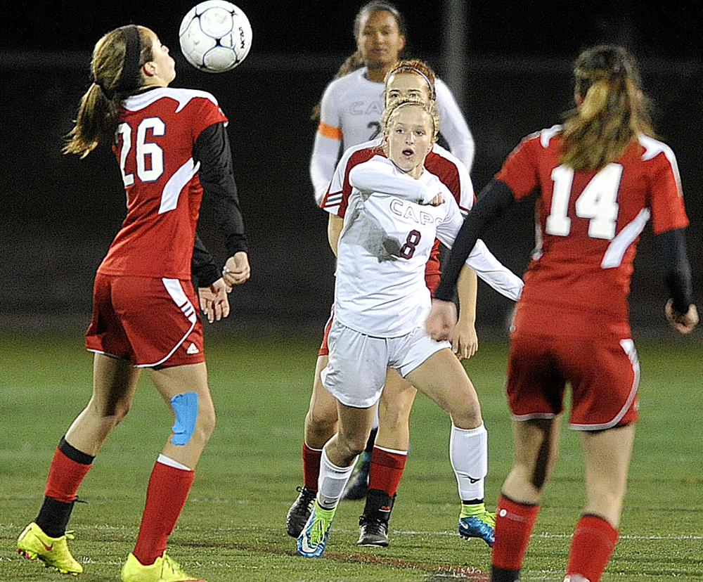 Kate Breed of Cape Elizabeth looks back upfield as Brianna Jordan of Gray-New Gloucester controls the ball in the second half of the girls’ soccer Class B quarterfinal at Hannaford Field on Tuesday evening. Looking on at right for GNG is Haley True, No. 14.