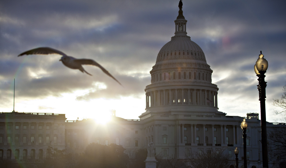 The sun sets over the U.S. Capitol in October 2015.