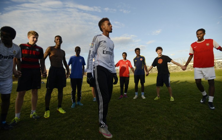 Lewiston High’s Abdi Shariff-Hassan, a soccer co-captain, talks with the team as the Class A state title game looms on Saturday.