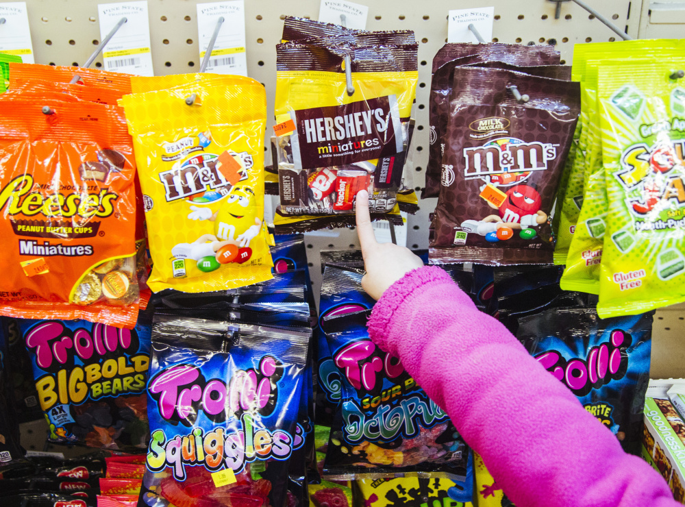 Sindel Theberge, 7, points to a bag of chocolate at Mellen Street Market. The state says poor food choices lead to chronic health problems.