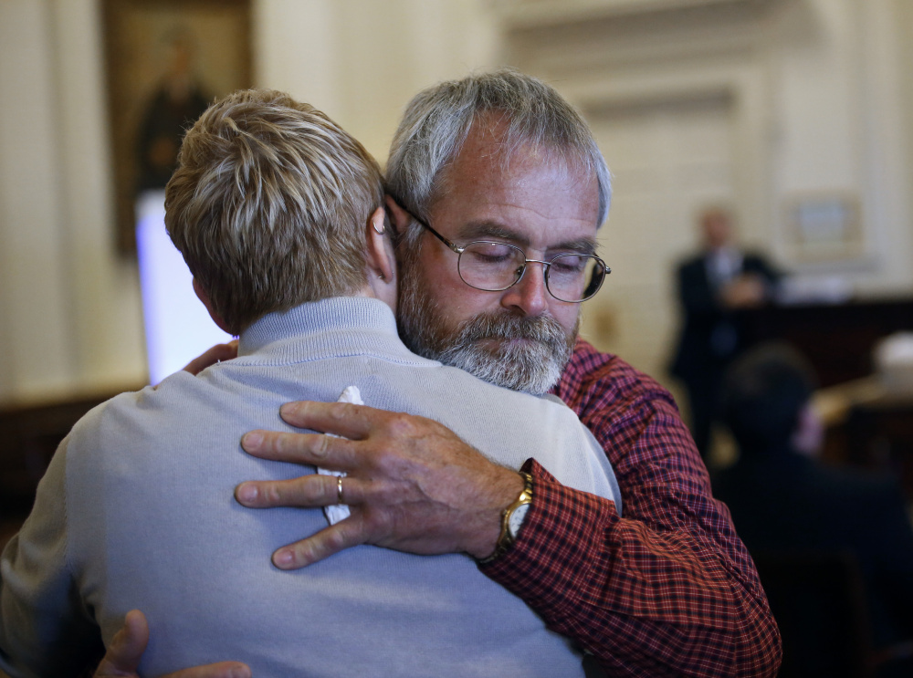 Jeffrey Boudreau, the husband of Wendy Boudreau, embraces one of his daughters after they testified in November 2015 at the sentencing hearing in Alfred for Connor MacCalister, who pleaded guilty to murdering Wendy Boudreau.