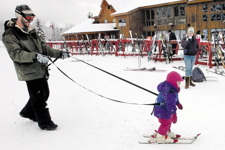 A father helps his daughter learn to ski at the Saddleback resort in Rangeley. The owners said in July that the resort would close if it couldn’t secure $3 million to replace an aging chairlift. This week they declined comment on Saddleback’s future.