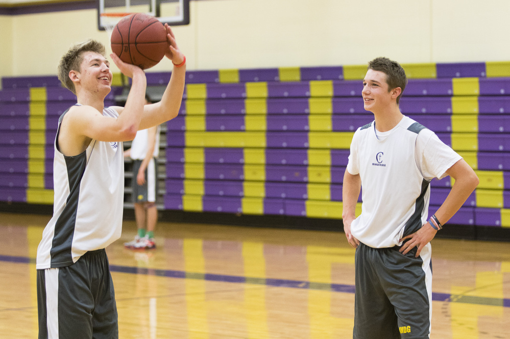 Austin Boudreau and Jack Casale of Cheverus share a light moment during practice Tuesday. The two guards are the central figures for a team looking to improve on a 10-8 record and regional quarterfinal exit.