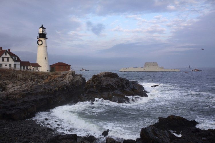 The U.S. Navy’s new Zumwalt-class stealth destroyer passes Portland Head Light on its way to Portland Harbor in December 2015.