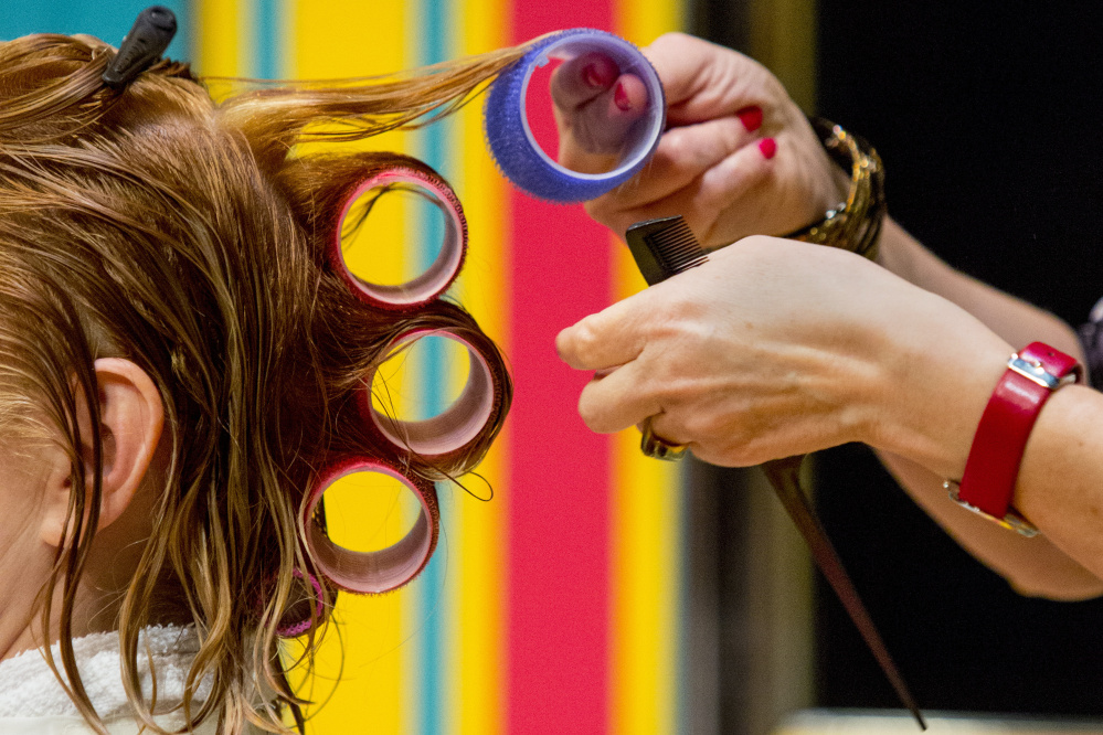 Mrs. Shubert, played by Laura Houck, at left, has her hair done by Barbara the hairdresser, played by Kathleen Kimball, during a rehearsal of "Shear Madness." Gabe Souza/Staff Photographer