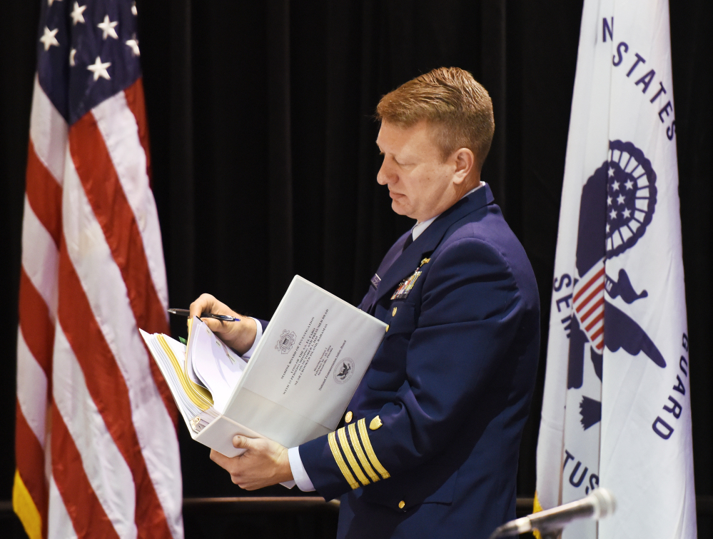 Coast Guard Capt. Jason Neubauer, the chairman of the El Faro hearing board, looks over his hearing notebook. 