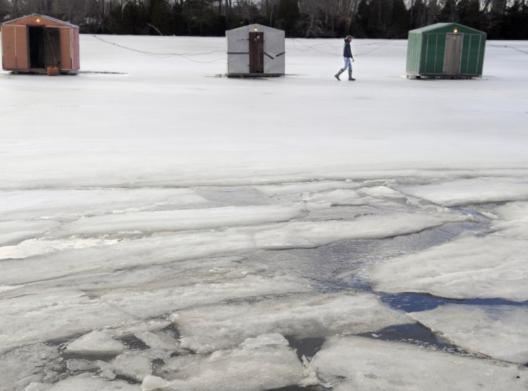 Peter James checks the smelt shacks his family maintains on the Eastern River in Dresden on Sunday. Anglers have been successful fishing on the tides at James Eddy, he said, but mild conditions and weak ice have restricted the season.