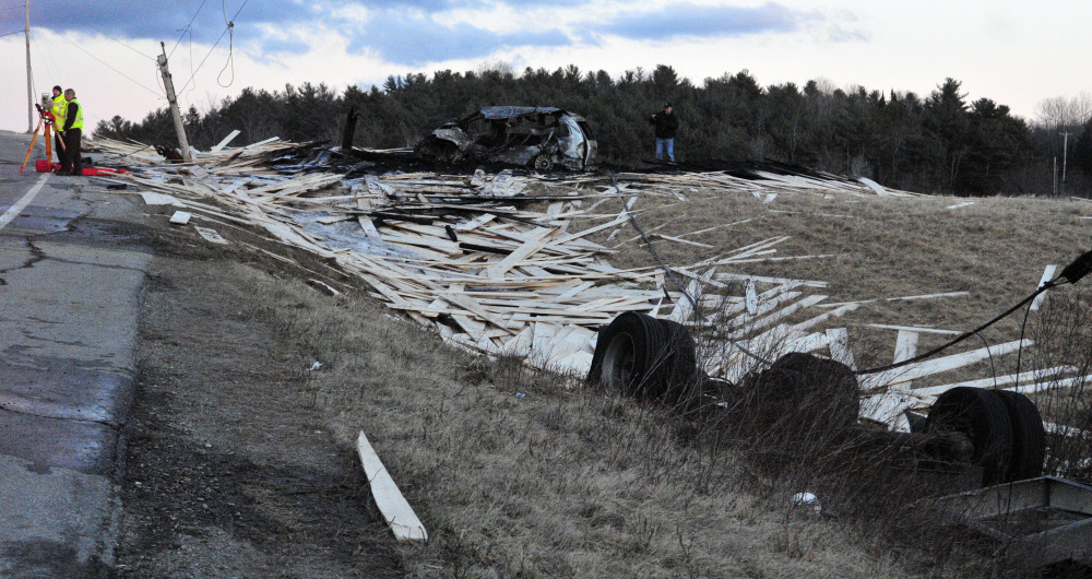 Police and firefighters work at the scene of Friday's crash on Route 17 near Fitch Road in Washington.
Joe Phelan/Kennebec Journal