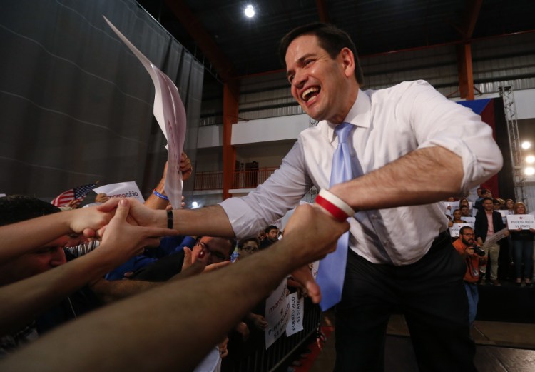 Florida Sen. Marco Rubio shakes hands at a rally in Toa Baja, Puerto Rico, on Saturday.