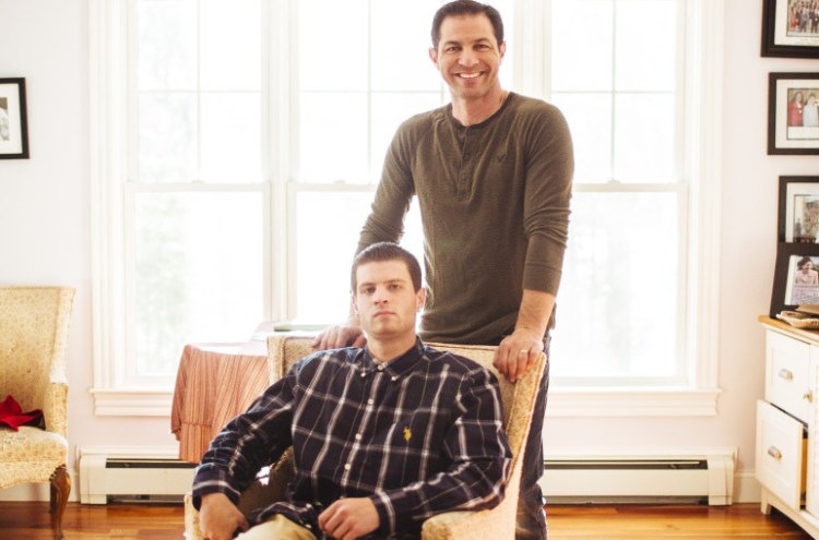 Derek Volk stands behind son Dylan, who has Aspberger’s syndrome, at their home in Scarborough, on Friday. Dylan is speaking at the Southern Maine Autism Conference on Saturday.
Whitney Hayward/Staff Photographer 