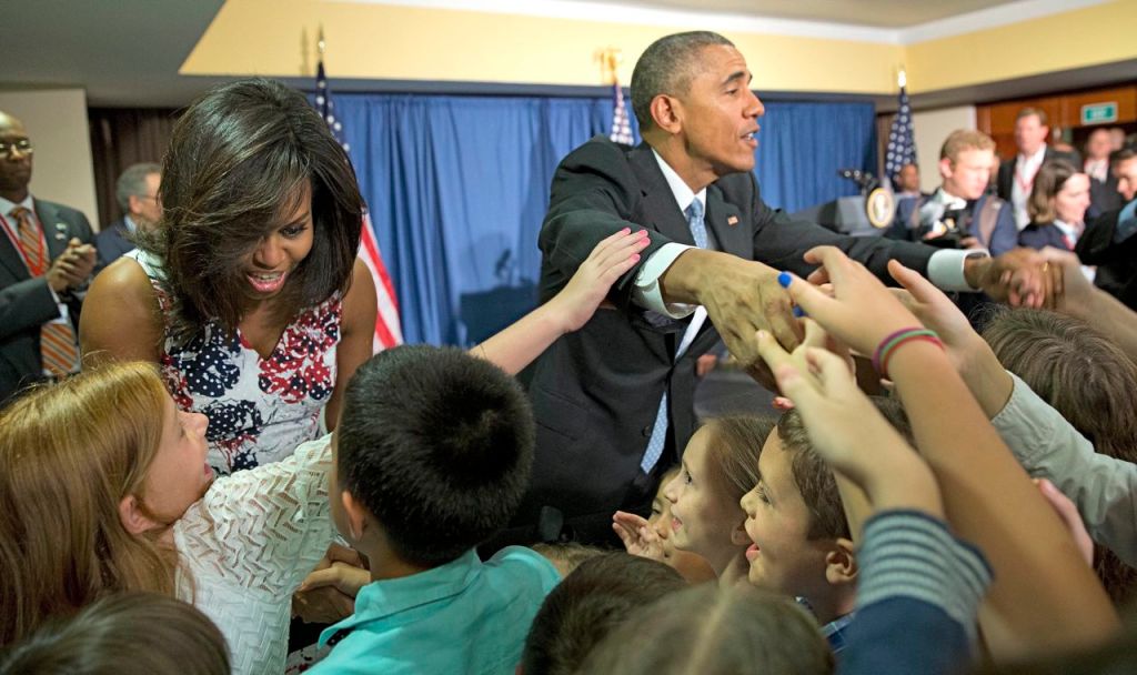 The Obamas greet children and families of Embassy personnel during an event at Melia Habana Hotel, in Havana on Sunday. The Associated Press