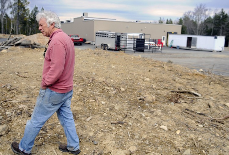 Central Maine Meats partner Joel Davis walks to what he plans to develop as pens for the firm's slaughterhouse in Gardiner on Monday.