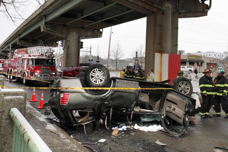 The Mercury Mountaineer rests on its roof in Bath after falling off the Route 1 viaduct Monday. Melissa Medina and her son were pulled from the SUV and taken to Maine Medical Center in Portland.