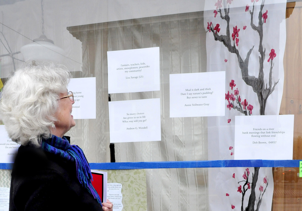 Nina Pleasants admires haiku poetry and artwork in a Skowhegan downtown storefront on Monday.