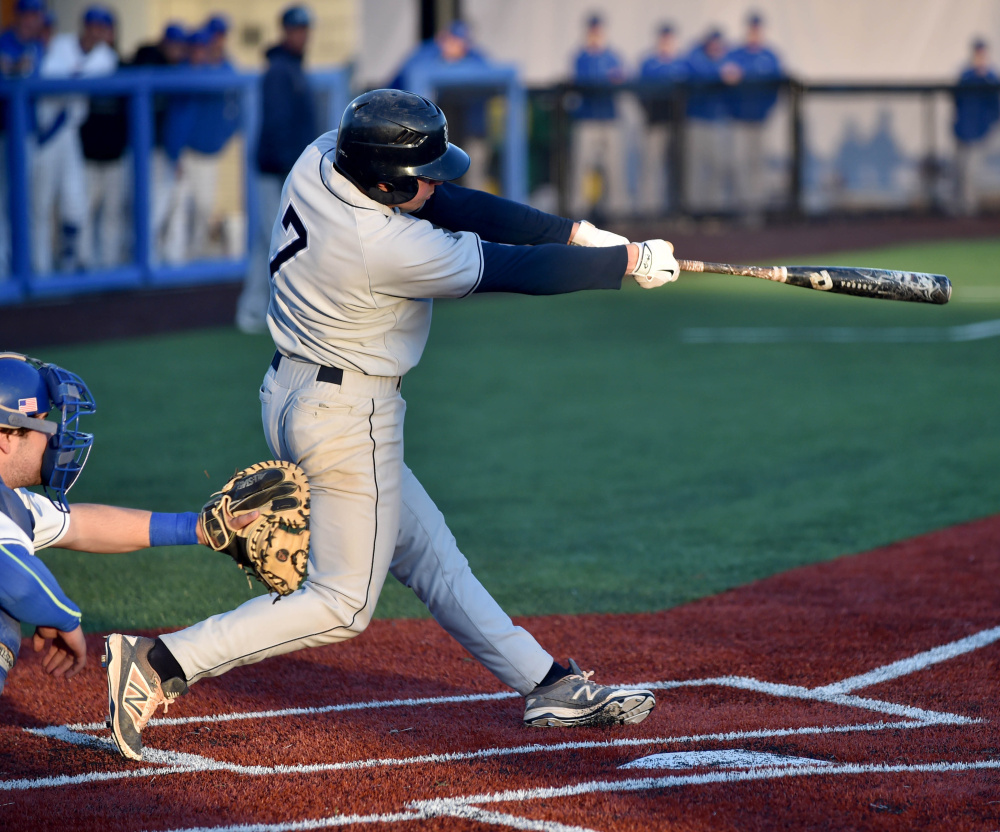 Southern Maine's Sam Dexter connects on a bases clearing triple in the 11th inning of a game against Colby in Waterville on Wednesday. The hit propelled the Huskies to a 10-7 victory.