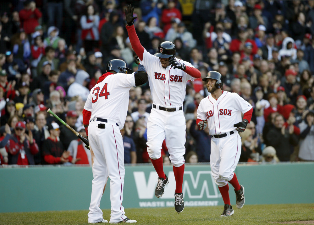 Xander Bogaerts, center, celebrates with David Ortiz and Dustin Pedroia after hitting a three-run homer that scored Pedroia and Jackie Bradley Jr. during the third inning of Boston's 4-2 win Saturday against the Toronto Blue Jays at Fenway Park.