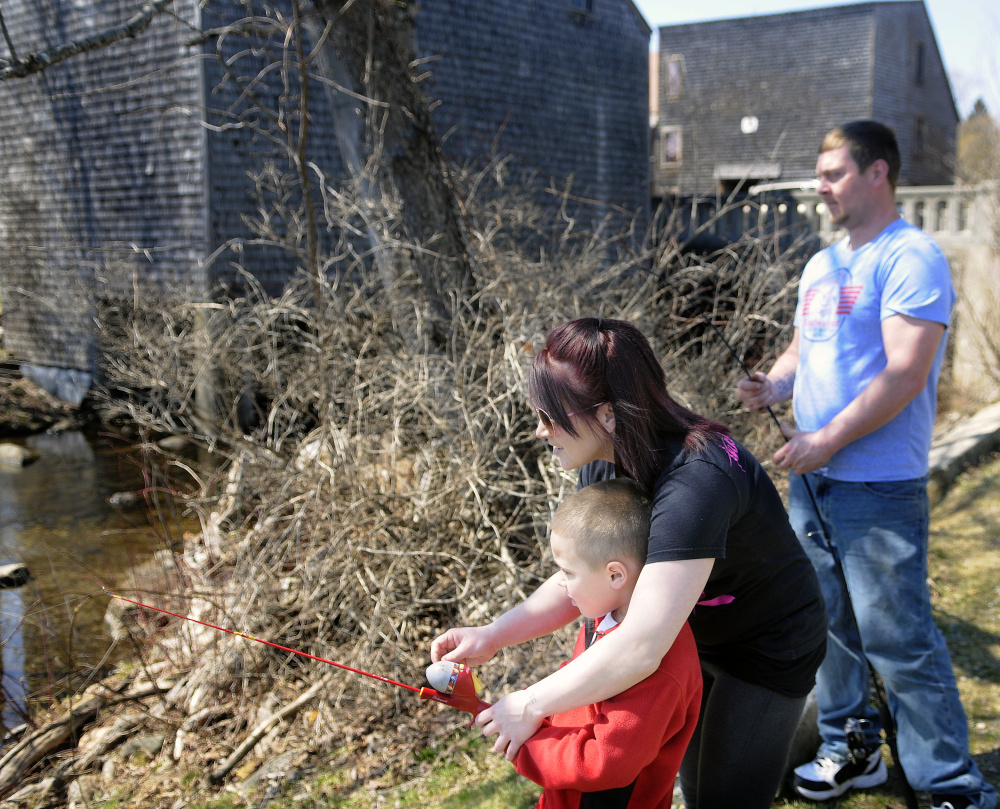 Katrina Bouchard, of Clinton, fishes on Sunday in Mount Vernon with her son, Brysen, 5, and their friend, Mike Savage, also of Clinton. Both adults said they have filed their taxes already.