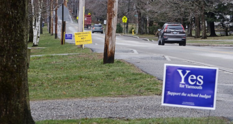 Signs for and against the Yarmouth school budget line West Elm Street with the final public hearing set for May 5.