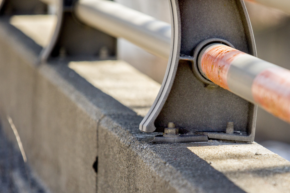 A guardrail support post is cracked and a nut is missing from the bolt at right on the Bath Viaduct. A 2014 inspection by a private contractor suggested that the Maine DOT repair the viaduct railing in six places.